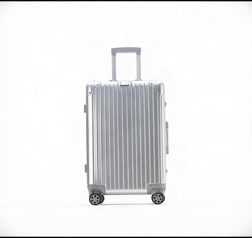 Silver suitcase with a ribbed texture on a white background