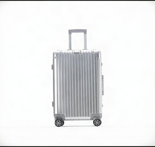 Silver suitcase with a ribbed texture on a white background
